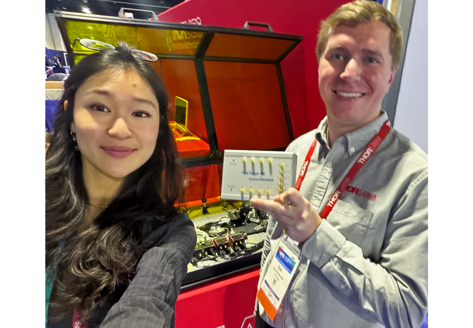 Ginger (Tingting) Geng from Swabian Instruments and Eric from Thorlabs at the Thorlabs exhibition booth at APS Global Physics Summit 2026, holding the Thorlabs Quantum Optics Educational Kit, which incorporates the Swabian Instruments Time Tagger 20 for quantum optics education and research.
