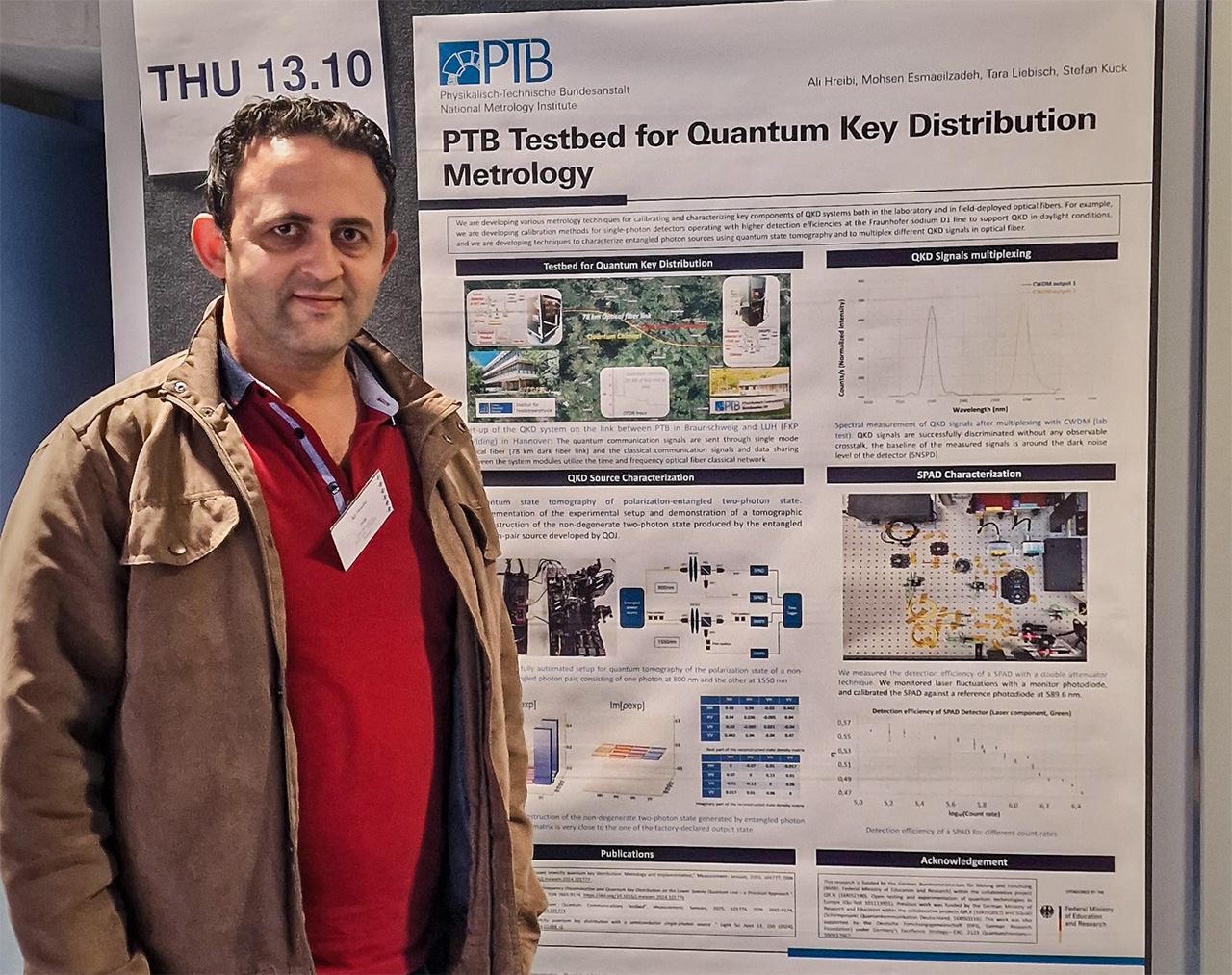 Ali Hreibi, PTB, standing with his poster, presenting a testbed for quantum key distribution metrology at DPG.